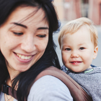 asian mom smiling at her baby