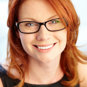cheerful redhead woman with glasses