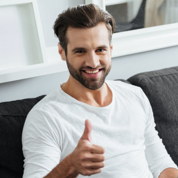 handsome man showing thumbs up