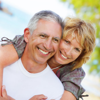 laughing couple of mature people in the garden