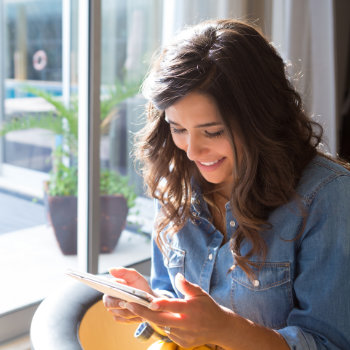 smiling Woman Using Tablet