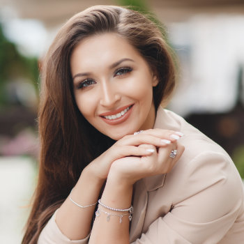 woman with brown long hair nice smile and silver bracelets