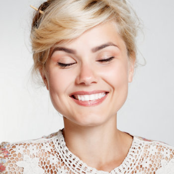 young smiling blonde with closed eyes