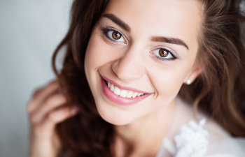 smiling brunette in white dress